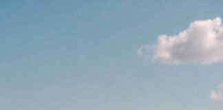 Best All-Inclusive Resorts That Families Actually Love kids running toward the ocean while a parent holds a beach bag looking half-tired/half-excited.