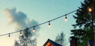 Couples-Only Resorts That Are Secretly the Best in the U.S. A cozy lakeside cabin at dusk with two glasses of wine on a wooden deck, warm golden lighting reflecting off the water