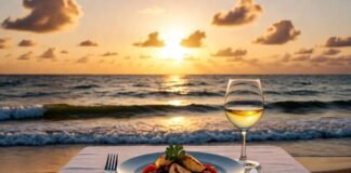 Gourmet Dining at Resorts That Rival Michelin-Star Restaurants Sunset shot from an outdoor table with ocean backdrop and plated seafood dish.