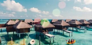 Luxury Resorts with Water Sports for the Adventurous Elite Overhead drone shot of a luxury overwater resort